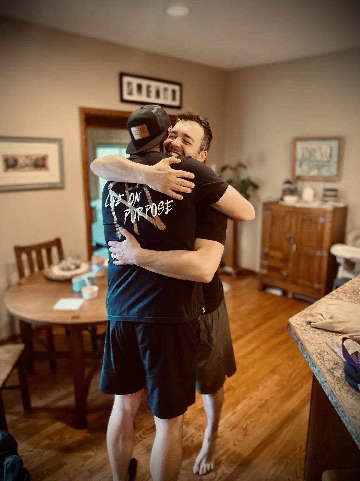 Two friends embracing while wearing TNP apparel